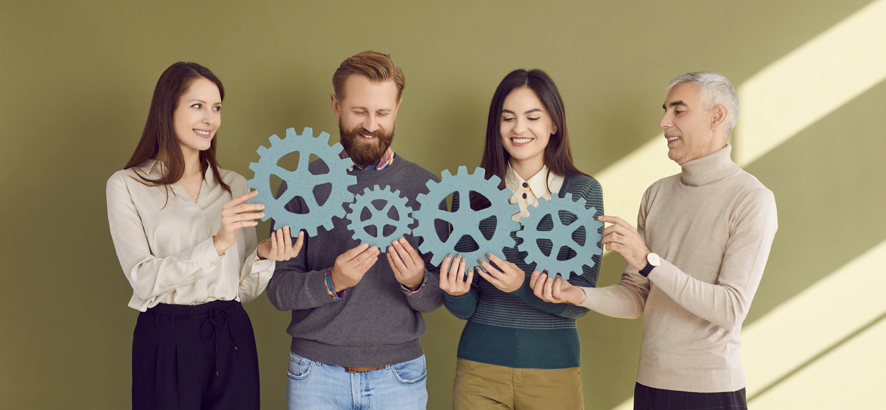 Four people with cogs