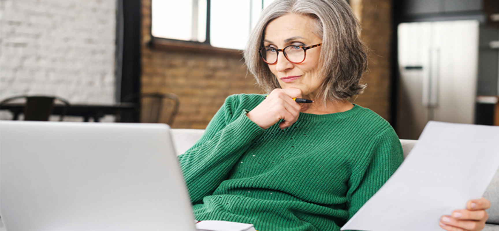 Older woman thinking on couch